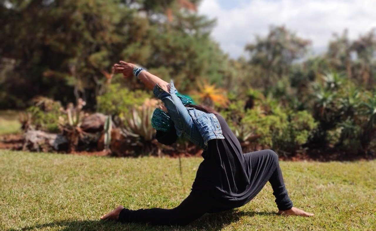 Ramashna Naidoo in an Anjaneyasana backbend pose outdoors